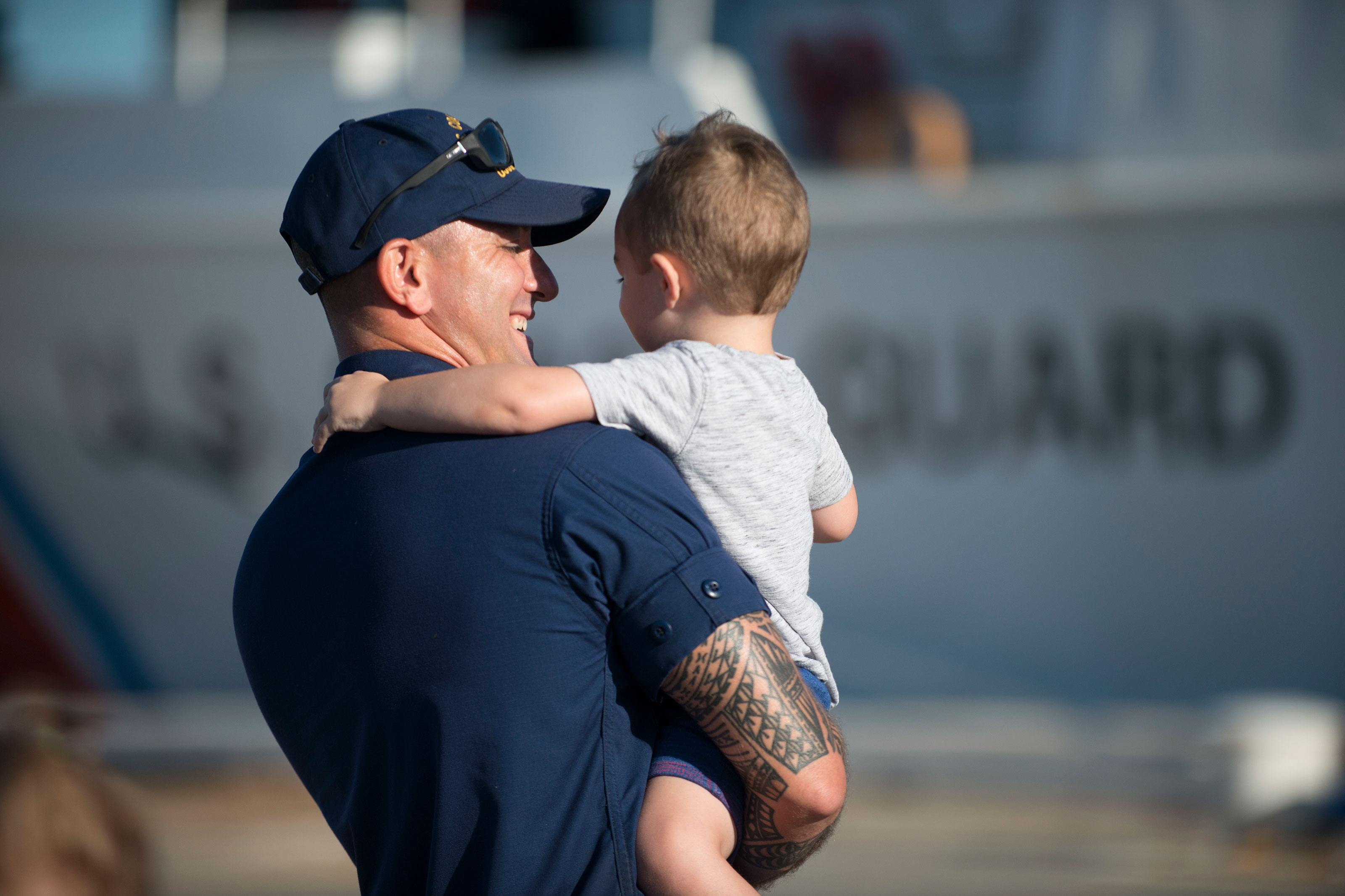 A Coast Guard Cutter Valiant crewmember hugs his child Friday, Sept. 29, 2017, at Naval Station Mayport, Florida. The Valiant crew returned to homeport after a 60-day multi-mission patrol in the Caribbean. (U.S. Coast Guard/Ryan Dickinson)