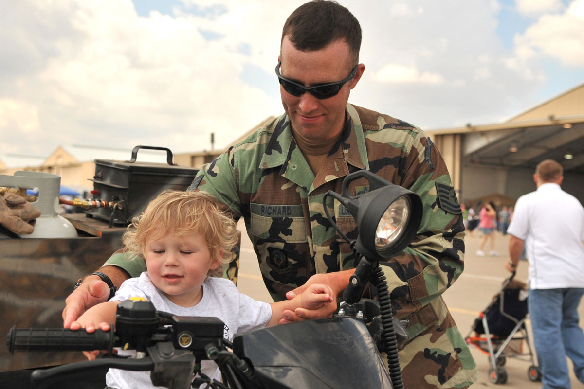 Special Operations Airman Sits on ATV with Son