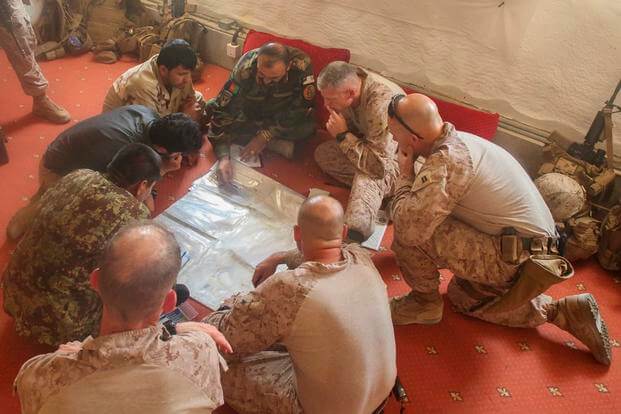 U.S. Marines with Task Force Southwest and Afghan National Army soldiers with the 215th Corps plan for the continuation of offensive combat operations at Camp Hanson, Afghanistan, June 13, 2017. (U.S. Marine Corps photo)