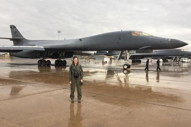 Military.com reporter Oriana Pawlyk stands in front of a B-1 bomber, tail "088," Dec. 19, 2017, at Dyess Air Force Base, Texas. (Photo by 7th Bomb Wing/Dyess Public Affairs)