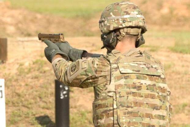 A service member fires the Sig Sauer P320 during Modular Handgun System tests for the U.S. Army Operational Test Command, conducted at Fort Bragg, N.C. Aug. 27. (Photo Credit: U.S. Army photo by Lewis Perkins)