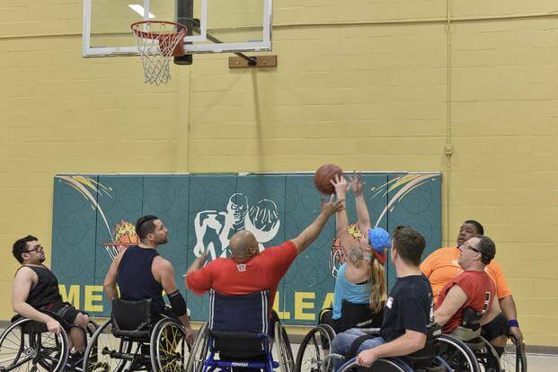 FILE -- An Air Force Wounded Warrior reaches for a rebound while playing wheelchair basketball practice to start February 13, 2018 at Baltimore County, Md. (U.S. Air Force/Staff Sgt. Alexandre Montes)