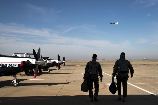 Lt. Col. Alexander Heyman, Commander, 71st Student Squadron, and 2nd Lt. Mitchel Bie, Vance student pilot, walk out to a T-6A Texan II, March 8, 2018, Vance Air Force Base, Okla. (U.S. Air Force photo by Airman Zachary Heal)