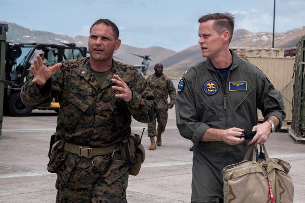  Rear Adm. Jeff Hughes, commander of Expeditionary Strike Group 2 (ESG-2), right, talks with Marine Lt. Col. Marcus Mainz, 26th Marine Expeditionary Unit (26th MEU) forward officer in charge, while both were embarked aboard the amphibious assault ship USS Kearsarge in September 2017 during relief efforts in the aftermath of Hurricane Irma. Mainz was relieved of command today. (Kaitlyn E. Eads/Navy)