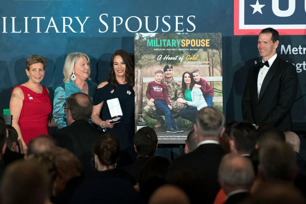 Krista Simpson Anderson, third from left, accepts the 2018 Armed Forces Insurance Military Spouse of the Year Award in Washington, D.C. May 10, 2018. With her are presenters Ellyn Dunford, Suzie Schwartz and Retired Lt. Gen. Stanley Clarke III. (Defense Department/EJ Hersom)