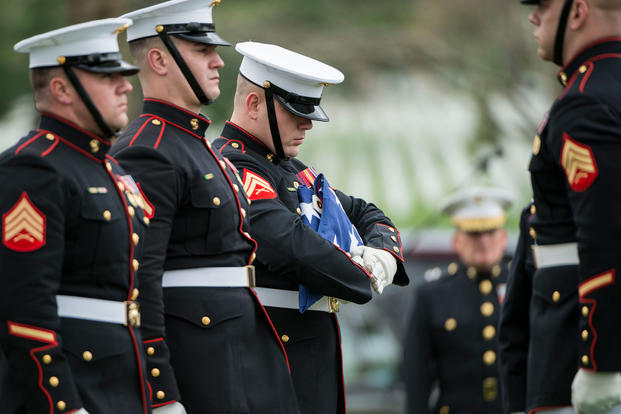  Marines from the Marine Barracks, Washington, D.C  fold the American flag during the full honors funeral of U.S. Marine Corps Col. Wesley Fox in Section 55 of Arlington National Cemetery, Arlington, Virginia, April 17, 2018. (U.S. Army/Elizabeth Fraser)