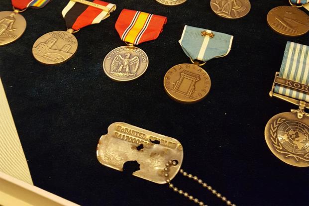 Army Master Sgt. Charles McDaniel’s dog tag and service medals on display. (Military.com/Richard Sisk)