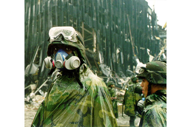 Wearing a gas mask, a New York National Guard soldier from the “Fighting” 69th Infantry Division pauses amid the rubble at ground zero. (New York National Guard)