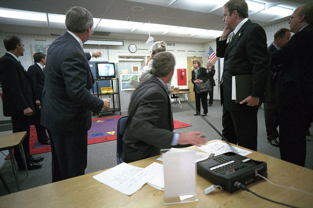 President George W. Bush turns around to watch television coverage of the attacks on the World Trade Center Tuesday, Sept. 11, 2001, as he is briefed in a classroom at Emma E. Booker Elementary School in Sarasota, Florida. (Photo by Eric Draper, courtesy of the George W. Bush Presidential Library)