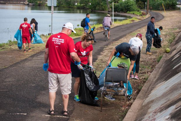 Active-duty service members, veterans and volunteers from Team Red, White & Blue clean a bike path at Neal S. Blaisdell Park along Pearl Harbor's historic waterfront in Aiea, Hawaii.