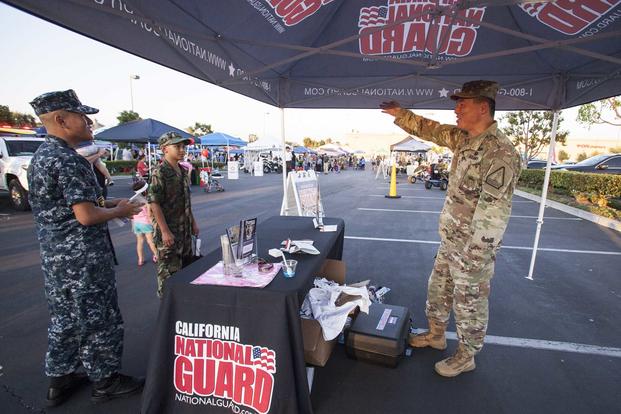 U.S. Army Master Sgt. Young Lee, a section chief with the California Army National Guard's Recruiting and Retention Command, talks with youth program cadets on Aug. 7, 2018, during National Night Out in Seal Beach, California. National Night Out is a nationwide event held at locations across the country to bring communities together with their local first responders and community-based organizations. (U.S. Air National Guard photo by Senior Airman Crystal Housman)