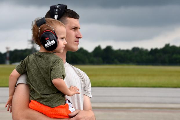 A father holds his son on the flightine at the 179th Airlift Wing in Mansfield, Ohio, on June 20, 2018. (U.S. Air Force photo/Christi Richter)