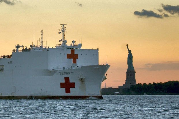 U.S. Navy hospital ship USNS Comfort passes the Statue of Liberty enroute to Manhattan to provide assistance to victims of the September 11th terrorist attack on the World Trade Center.