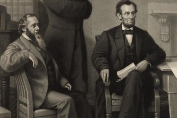 Secretary of War Edwin Stanton and Abraham Lincoln depicted at the signing of the Emancipation Proclamation. (Library of Congress)