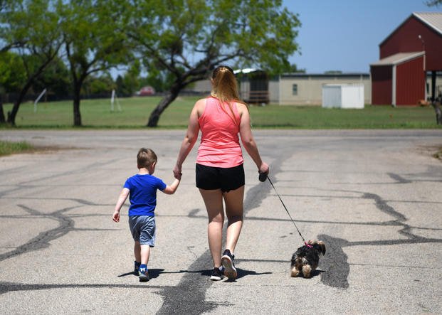 mother and son walking dog