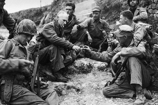Ernie Pyle (centre left) with a U.S. Marine patrol during the Pacific campaign in World War II. Pyle himself would die in the Pacific. (DoD Photo)