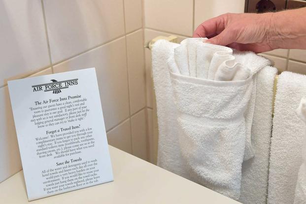 A housekeeper hangs clean towels at the General John K. Cannon Hotel.