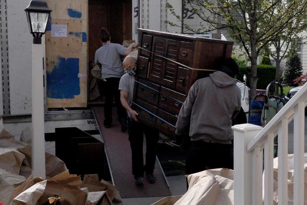 Movers unload household goods after a delivery. 
