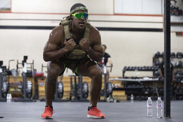 An Army soldier performs air squats during a Murph Workout.