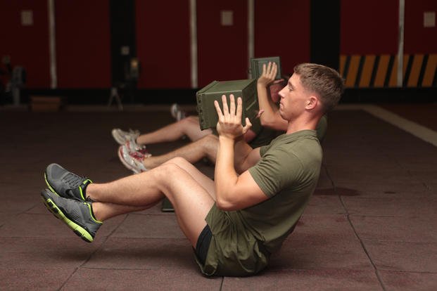Marines participate in a HITT workout.