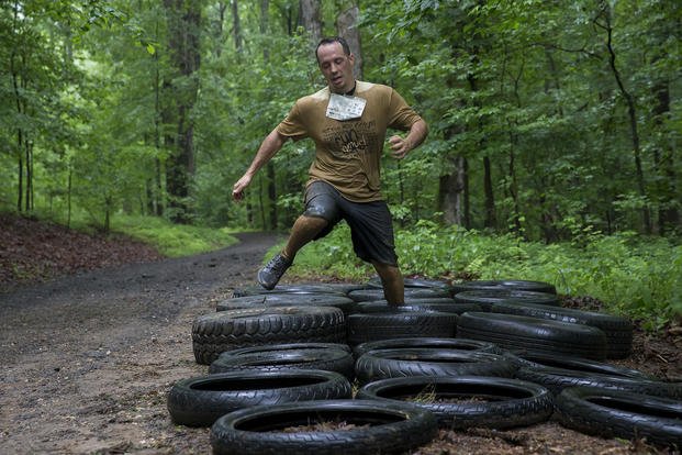 A participant navigates a tire obstacle during the Marine Corps Marathon Run Amuck.