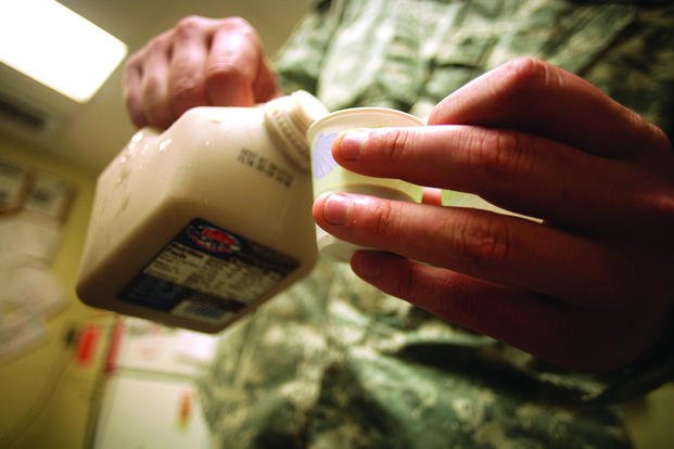 A food inspector pours a glass of milk at Parris Island.