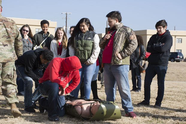 Army recruiters gather with high school students for an education event at Fort Sill, Oklahoma.