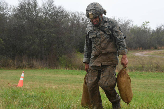 An Air National Guardsman carries sandbags during the Texas Military Department Best Warrior Competition.