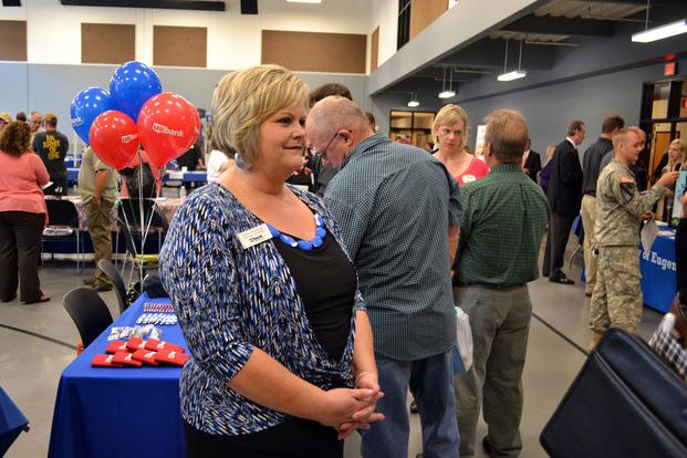 Kathy Heavirland, district operations manager with U.S. Bank, discusses job opportunities with veterans at the Lane County Armed Forces Reserve Center in Springfield, Ore., during a Hero2Hired (H2H) job fair.