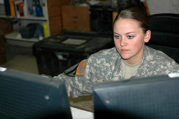 An intelligence analyst from 1st Air Cavalry Brigade monitors a computer in the brigade security section in Iraq.