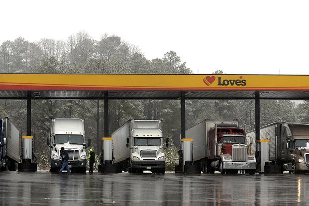 Truck drivers stop at a gas station in Emerson, Ga.