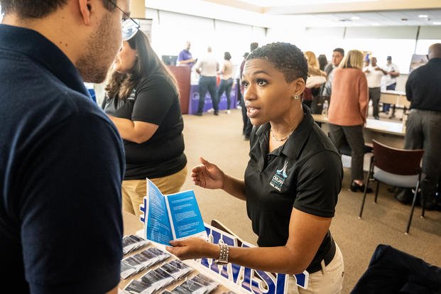 Tameka Cunningham-Preyer, Air Force Installation and Mission Support Center program and management analysts, speaks with a prospective new civilian hire at a Joint Base San Antonio civilian hiring event at St. Philip’s College, San Antonio.
