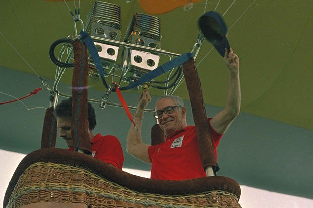 Malcolm Forbes, chairman of Forbes magazine, waves from the gondola as he departs on a demonstration flight of a hot-air balloon in Japan.