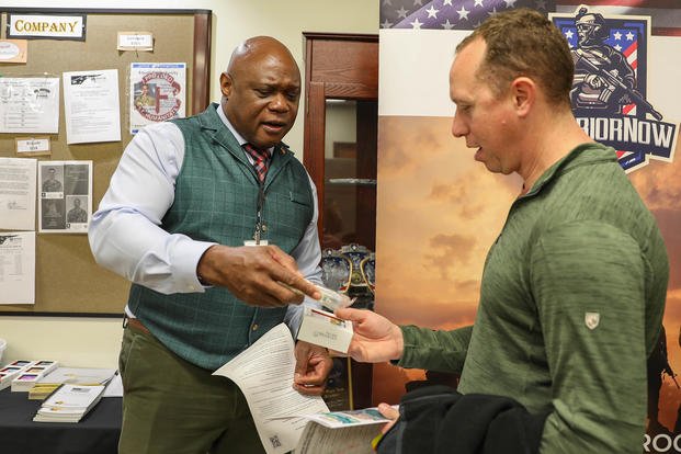 Sgt. 1st Class Brian Reynolds receives information from Terry Brown, a Transition Assistance Program counselor, on Fort Carson, Colorado.