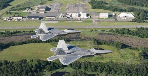 Two U.S. Air Force F-22 Raptors fly over Joint Base Langley-Eustis’ Felker Army Airfield at Fort Eustis, Virginia, June 14, 2018.