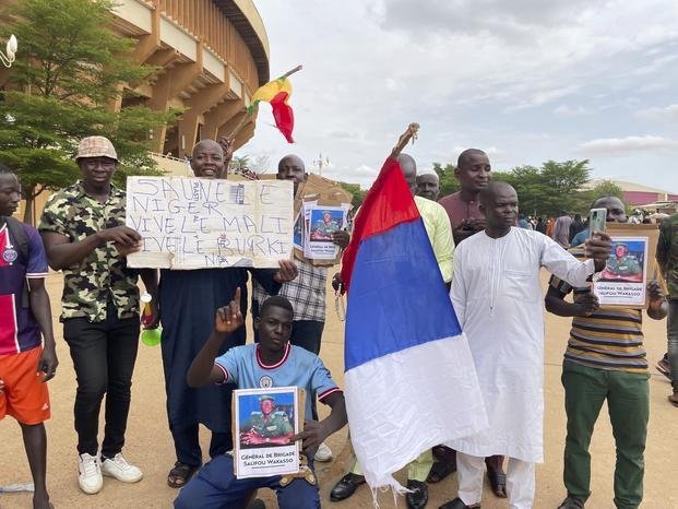 Supporters of Niger's ruling junta hold a Russian flag in Niamey, Niger