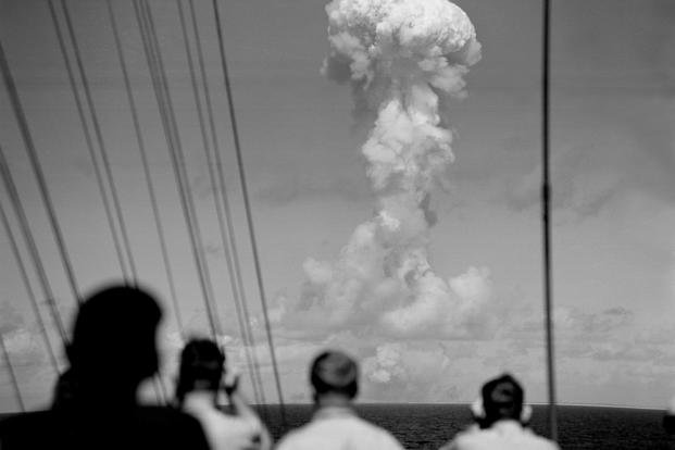 Observers on the bridge of the USS Mount McKinley watch a huge cloud mushroom over Bikini atoll in the Marshall Islands, July 1, 1946, following an atomic test blast, part of the U.S. military's ‘Operation Crossroads.’ 
