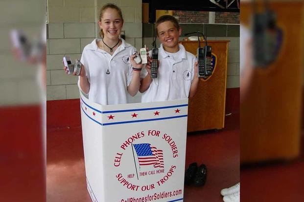 Brittany and Rob Bergquist, ages 12 and 11, pose in one of the first Cell Phones for Soldiers collection boxes at a Massachusetts police station. (Cell Phones for Soldiers)