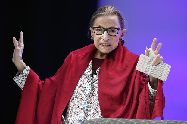 In this Oct. 3, 2019, file photo, U.S. Supreme Court Justice Ruth Bader Ginsburg gestures to students before she speaks at Amherst College in Amherst, Mass. (Jessica Hill/AP Photo) In this Oct. 3, 2019, file photo, U.S. Supreme Court Justice Ruth Bader Ginsburg gestures to students before she speaks at Amherst College in Amherst, Mass.