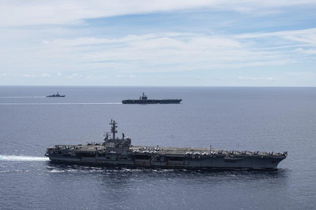 In this July 6, 2020, file photo provided by U.S. Navy, the USS Ronald Reagan (CVN 76, front) and USS Nimitz (CVN 68, rear) Carrier Strike Groups sail together in formation, in the South China Sea. (Mass Communication Specialist 3rd Class Jason Tarleton/U.S. Navy via AP, File) In this July 6, 2020, file photo provided by U.S. Navy, the USS Ronald Reagan (CVN 76, front) and USS Nimitz (CVN 68, rear) Carrier Strike Groups sail together in formation, in the South China Sea. (Mass Communication Specialist 3rd Class Jason Tarleton/U.S. Navy via AP, File)