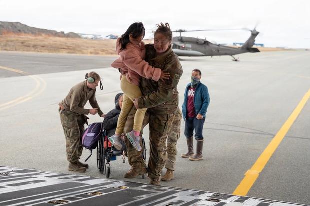 Alaska Air National Guard Tech. Sgt. Annie Kilborn, foreground, a C-17 Globemaster III loadmaster assigned to the 144th Airlift Squadron, 176th Wing, assists a child while evacuating approximately 300 displaced Alaskans out of Bethel, Alaska, Oct. 15, 2025 (Alaska National Guard photo by Staff Sgt. Joseph Moon, DVIDS).