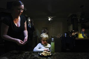 Heather Drain serves dinner to her son.
