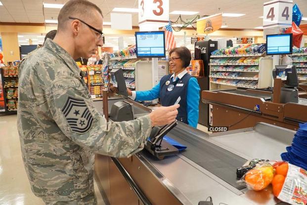 Chief Master Sgt. Stuart Allison, DeCA senior enlisted advisor, was the first to swipe a MILITARY STAR card at the commissary during a rollout ceremony at Oct. 5 at Fort Lee. (Army Photo)