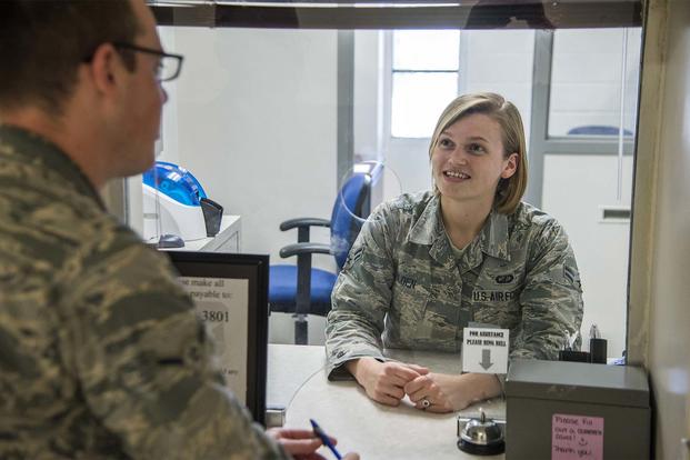 Airman 1st Class Bridget Golden, 502nd Comptroller squadron cashier, assists a customer with military pay June 23, at JBSA-Lackland. (Photo by Johnny Saldivar)