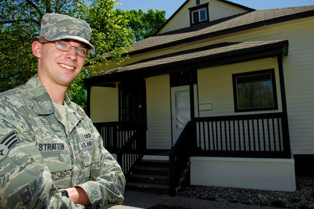 Senior Airman Benjamin Stratton, 5th Bomb Wing public affairs, poses for a photo outside his newly purchased home, May 18, 2010. (Photo: U.S. Air Force)