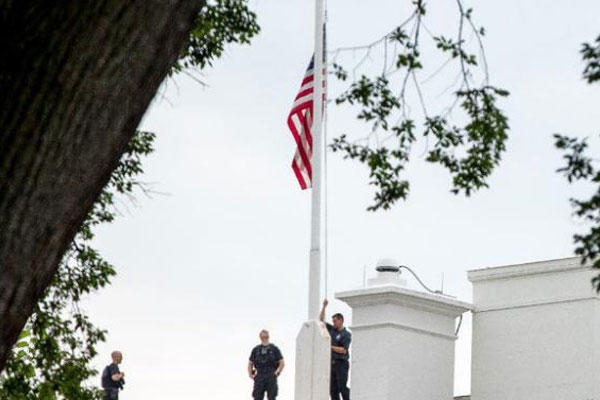 The American flag is lowered to half-staff above the White House in Washington, Tuesday, July 21, 2015, to honor the five U.S. service members who were killed by a gunman in Chattanooga, Tenn. last week (AP Photo/Andrew Harnik)