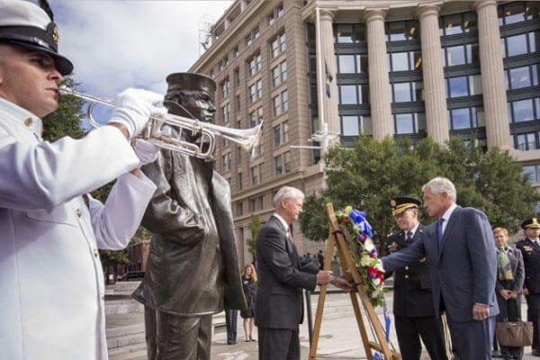 Defense Secretary Chuck Hagel, right, and Joint Chiefs Chairman Gen. Martin Dempsey, second from right, present a wreath at the Navy Memorial in Washington to remember the victims of Monday's deadly shooting at the Washington Navy Yard, Tuesday, Sept. 17.