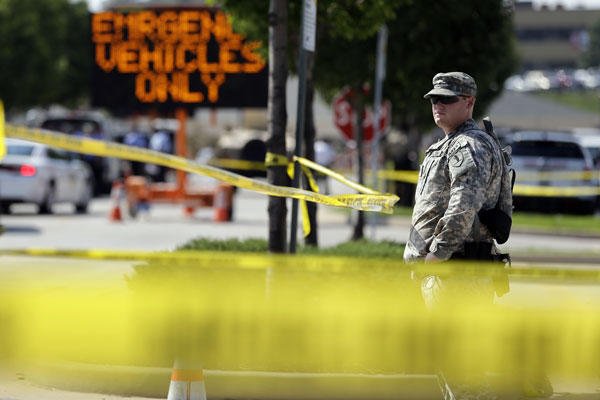 A member of the Missouri National Guard stands guard at a police command post Tuesday, Aug. 19, 2014, in Ferguson, Mo. (AP Photo/Jeff Roberson)