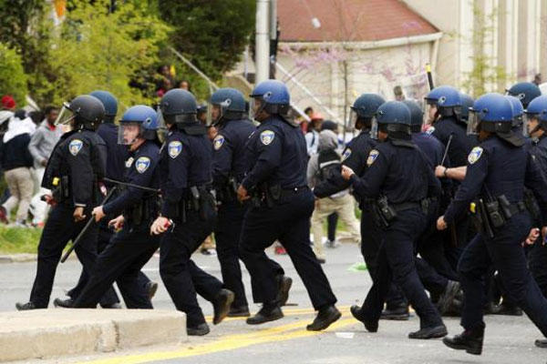 Baltimore police officers push back demonstrators who are throwing rocks at the police, after the funeral of Freddie Gray, Monday, April 27, 2015, at New Shiloh Baptist Church in Baltimore. (AP Photo/Jose Luis Magana)