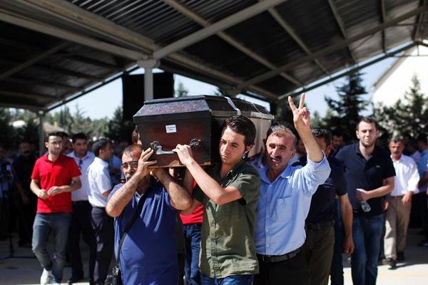 Mourners carry a coffin during a funeral ceremony for the victims of a suicide bomb attack in southern Turkey that killed 32 people. ISIS militants are suspected to be behind the blast. (Gokhan Sahin/Getty Images)